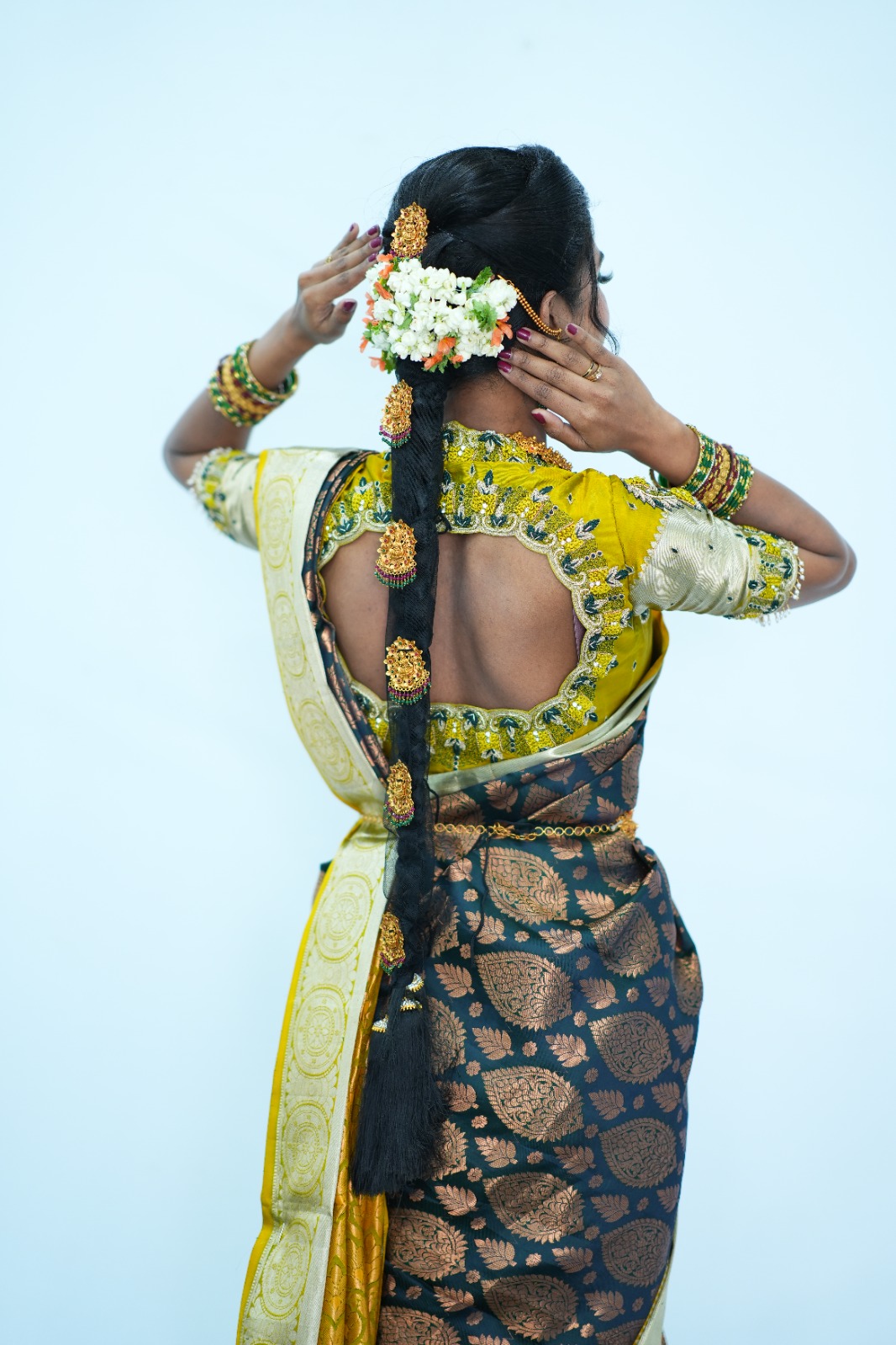 Traditional hairstyle with flowers from back